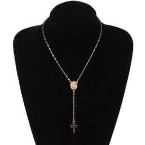 Three-tone Virgin Mary and cross Y-necklace in gold finish on black jewelry display