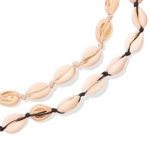 Handmade shell necklaces with beige and black cords on a clean white background