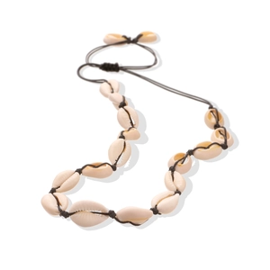 Detail view of handmade Bohemian cowrie shell necklace with dark woven rope knot