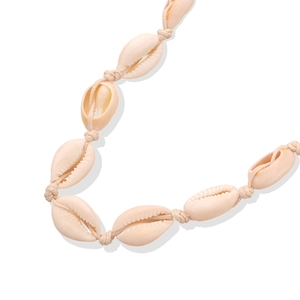 Detailed close-up of handmade cowrie shell necklace with knotted bohemian weaving cord
