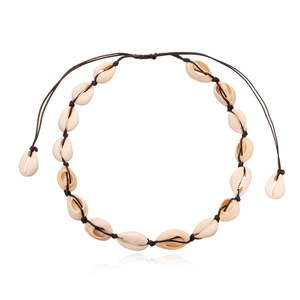 Handmade Hawaiian cowrie shell necklace with adjustable black cord on white background