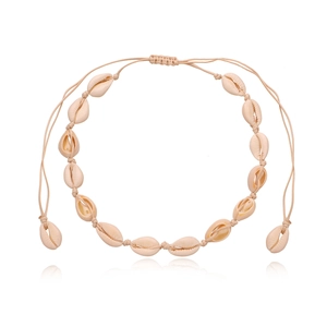 Detailed view of handmade cowrie shell choker with adjustable beige braided cord