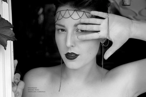 Detail of gothic punk metal chain headband, double finger ring and long tassel earrings
