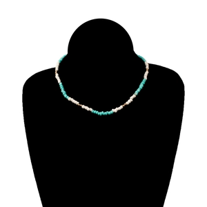 Colorful handmade beaded necklace with turquoise and white beads on a black silhouette