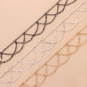 Detail of lattice metal chains in gold silver and gun black finishes with punk style