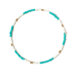 Detail view of colorful turquoise white and gold beaded collar necklace for women