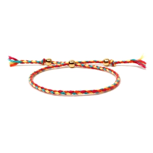 Detailed view of handmade colorful braided cord bracelet with adjustable gold metal beads