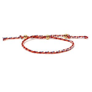 Detail of colorful woven cord bracelet with three gold beads and adjustable slider knot