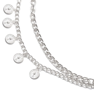 Detailed macro view of silver layered punk chain body jewelry with queen coin pendants