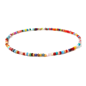 Detail shot of a handmade colorful seed bead necklace with vibrant Bohemian summer style