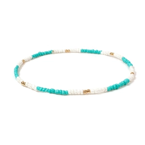 Detail view of handmade bohemian necklace with turquoise and white beads and gold accents