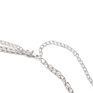 Close-up of adjustable silver chain extension with lobster clasp for body jewelry