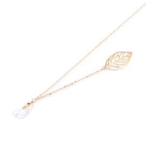 Detailed close-up of a gold metal eyewear chain with a hollow leaf pendant and silicone loops