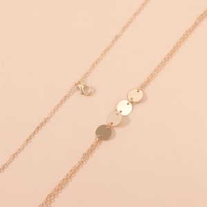 Minimalist gold multi-layer body chain with circular sequin pendants and lobster clasp
