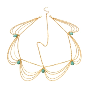 Detail of gold multi-layer chain bra body jewelry with blue turquoise teardrop stones