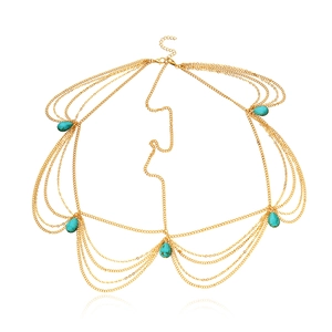 Detail of bohemian gold multi-layer body chain with turquoise teardrop beads