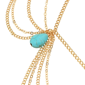 Close-up of golden multilayer chains with a turquoise teardrop bead for bohemian headwear