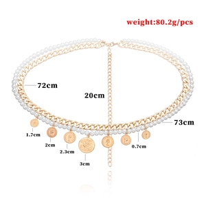 Golden multi-layer body chain with pearls and vintage coins on a white background