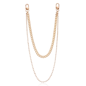 Detail of a double-layered gold chain with thick curb links and shimmering rhinestones