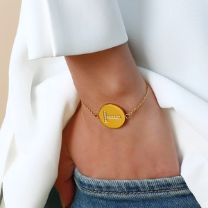 Adjustable gold stainless steel letter T bracelet with zircon stones on female model wrist