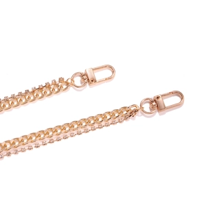 Close-up of golden metal body chain with double layers of flat links and sparkling rhinestones