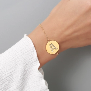 Detailed macro of gold plated letter A charm bracelet with micro-pave cubic zirconia stones