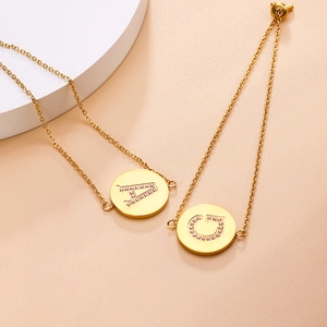 Detailed close-up of gold stainless steel bracelet with zircon inlaid letter charms