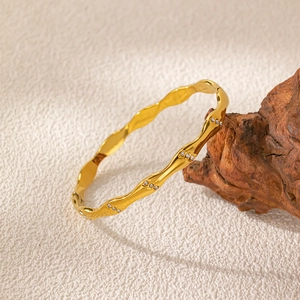 Vintage gold wave bangle in titanium steel with zircon accents for a minimalist style