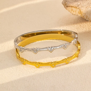 Titanium steel bangles featuring openwork heart patterns with inlaid cubic zirconia stones