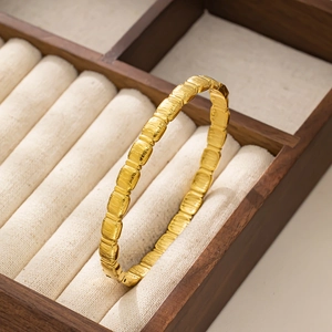 Macro shot of 18K gold plated bamboo bangle with brushed texture in a jewelry box