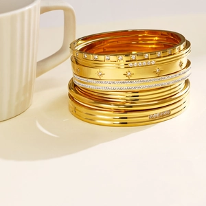 Detailed view of luxury gold-plated stainless steel bangles with sparkling zircon accents