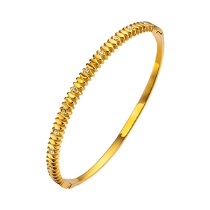 Elegant gold twisted stainless steel bangle with zircon heart accents and wavy texture