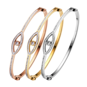 Three-color 18K gold plated evil eye bangles with micro-paved crystals in stackable design