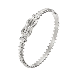 Detail of silver titanium steel bracelet with twisted knot and sparkling zircon accents