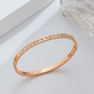 Detail view of rose gold stainless steel bracelet with rectangular cubic zirconia inlay