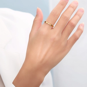 Detailed view of minimalist 18k gold plated stainless steel ring with a single solitaire diamond
