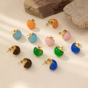 Detail of colorful resin stud earrings with 18k gold plating and marble textures