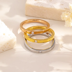 Minimalist stainless steel rings set in gold, rose gold, and silver with single zircon