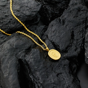 18k gold plated rope chain necklace with sunflower oval pendant on black rock