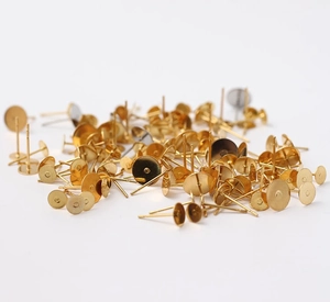 Close-up of bulk gold-plated 316 stainless steel flat head earring pins for DIY jewelry making
