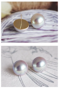 Detailed macro view of hemispherical aurora pearl earrings with gold-plated flat pins