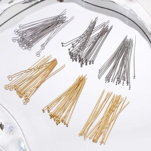 Close-up of assorted stainless steel eye pins, ball head pins and flat head pins for DIY jewelry