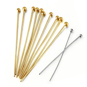 Detailed close-up of gold and silver round head beaded pins for DIY jewelry making