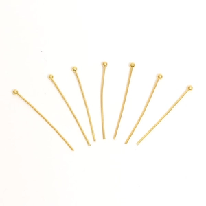 Eight gold-plated stainless steel ball head pins for DIY jewelry making on white background