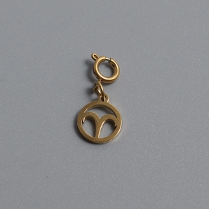 Macro shot of gold plated Aries zodiac pendant with round spring ring clasp for DIY jewelry