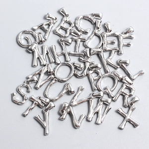 Detailed close-up of a full set of silver bamboo-textured A-Z initial letter pendants