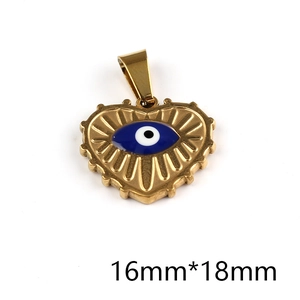 Detail of a 16x18mm gold heart charm featuring a blue evil eye and radial engravings