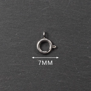 Detailed macro view of a 7mm stainless steel spring ring clasp for jewelry making
