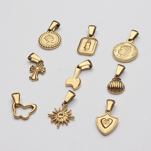 Collection of golden vintage coin, cross, and heart charms for DIY jewelry making