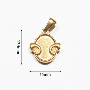 Macro detail of vintage gold-plated oval heart pendant with embossed scroll motifs